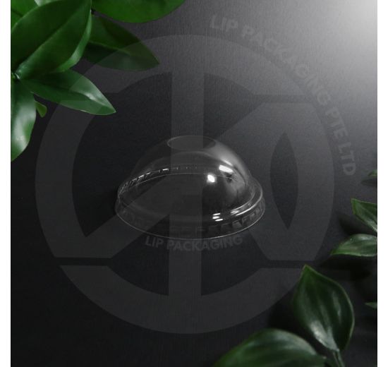 Clear dome plastic lid covering a small paper cup of ice cream with toppings visible underneath.