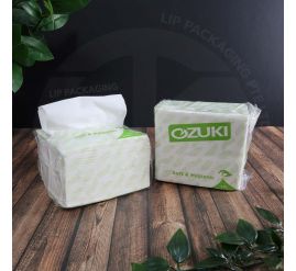 A stack of Ozuki 2-ply white tissue packs (180 sheets each), indicating bulk supply for Singapore businesses.