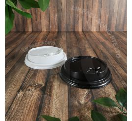 A white C90P 90mm Pop Out lid securely fastened on a 16oz double wall paper coffee cup, with the flip cap closed to prevent spills.